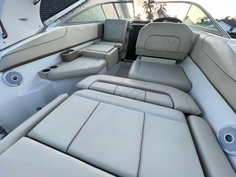 Slide: The Image of 2020 Regal 26 XO boat interior with beige seating and cup holders. - 25
