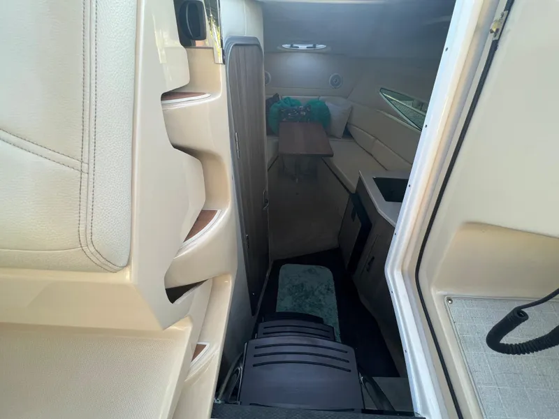 Slide: The Image of Interior view of 2020 Regal 26 XO boat cabin with seating and table. - 27