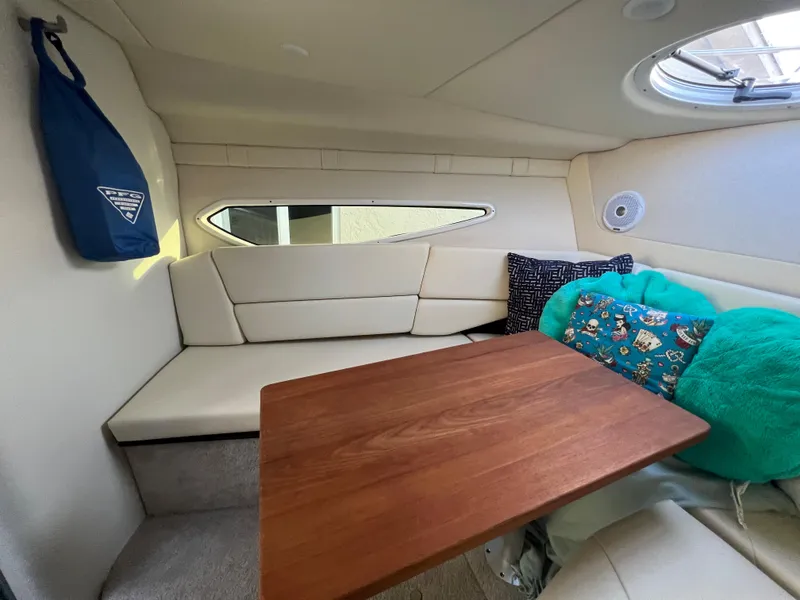 Slide: The Image of Cozy interior of 2020 Regal 26 XO boat with wooden table and cushioned seating. - 31