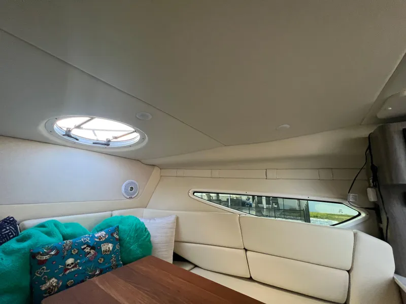 Slide: The Image of Interior of 2020 Regal 26 XO boat with cozy seating and porthole window. - 32
