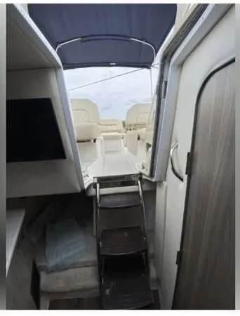 Slide: The Image of 2020 Regal 26 XO boat interior with stairs and seating area. - 40