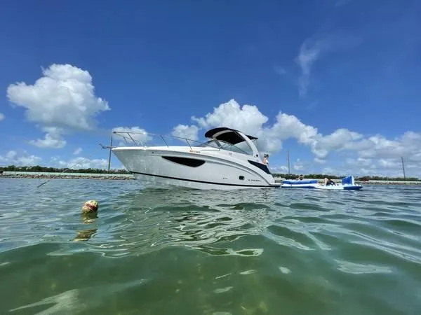 Slide: The Image of 2020 Regal 26 XO boat on calm water under a clear blue sky. - 48