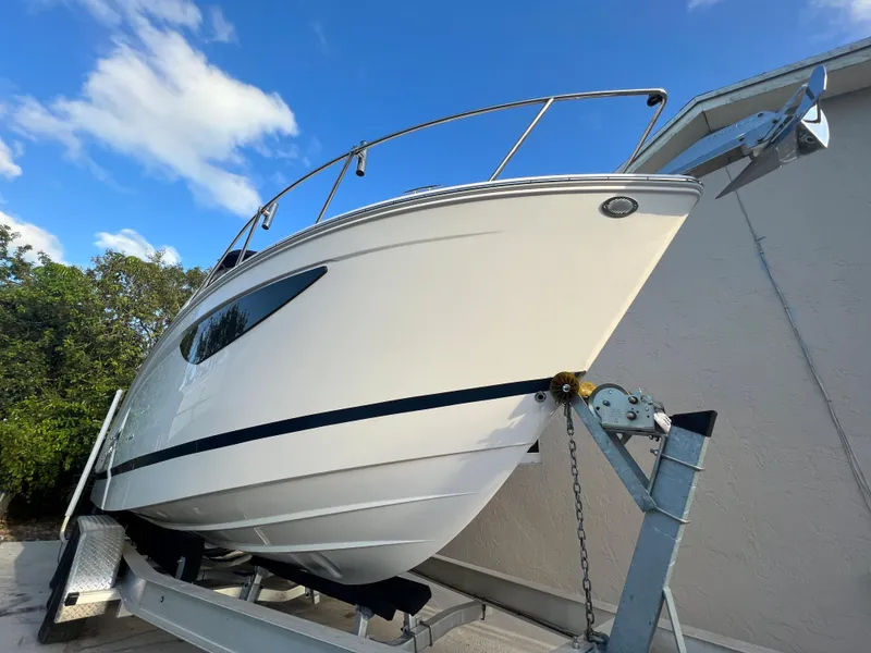 Slide: The Image of 2020 Regal 26 XO boat on trailer, side view under blue sky. - 6