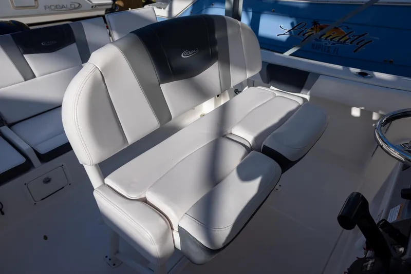 Slide: The Image of 2020 Robalo R230 Center Console boat seat, featuring white and black cushioned design. - 12