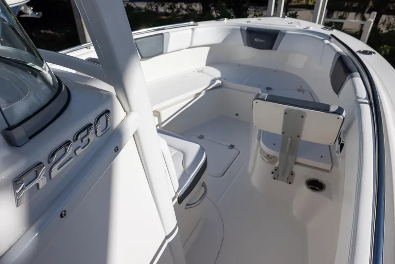 Slide: The Image of 2020 Robalo R230 Center Console boat interior with seating and storage. - 13