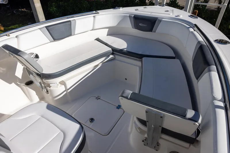 Slide: The Image of 2020 Robalo R230 Center Console boat interior with cushioned seating and storage compartments. - 14