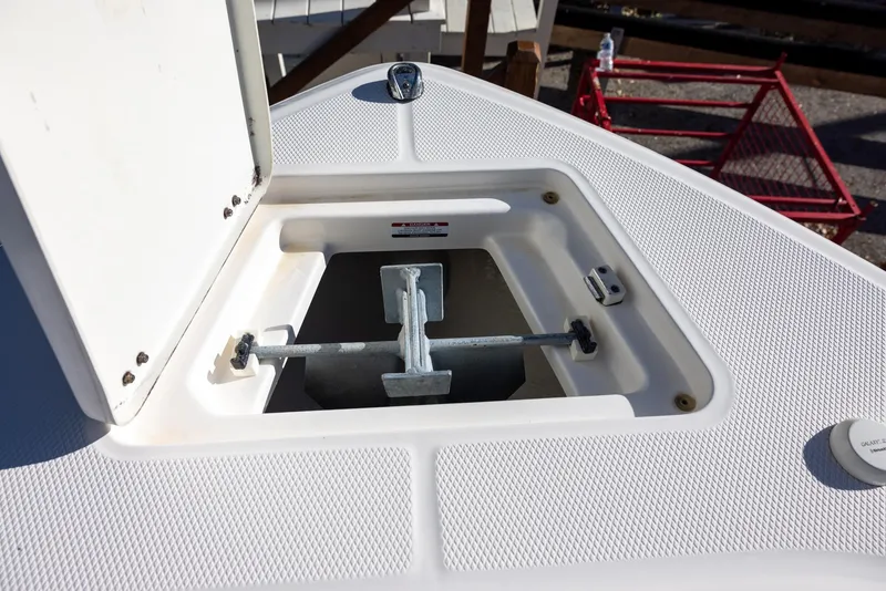 Slide: The Image of Anchor storage compartment on a 2020 Robalo R230 Center Console boat. - 16