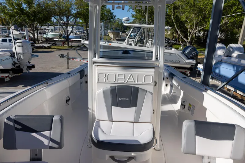 Slide: The Image of 2020 Robalo R230 Center Console boat with seating, docked at a marina. - 17