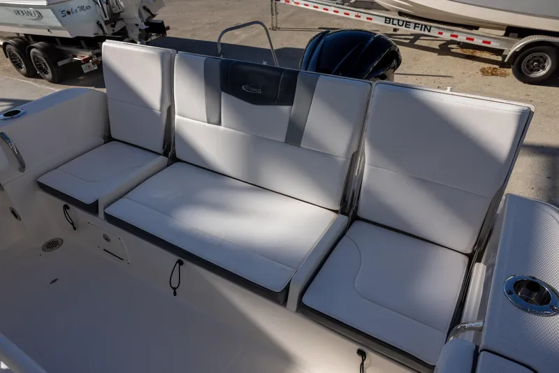 Slide: The Image of 2020 Robalo R230 Center Console boat seating area with cushioned seats and backrests. - 6