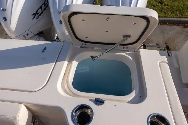Slide: The Image of 2024 Grady-White Freedom 375 boat with open storage compartment and visible outboard engines. - 13
