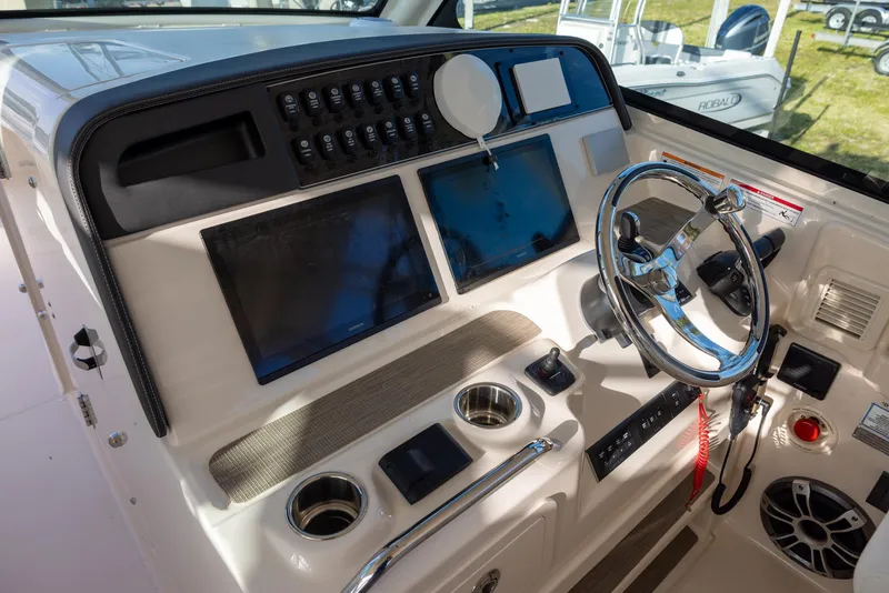 Slide: The Image of 2024 Grady-White Freedom 375 helm with dual screens and modern controls. - 18
