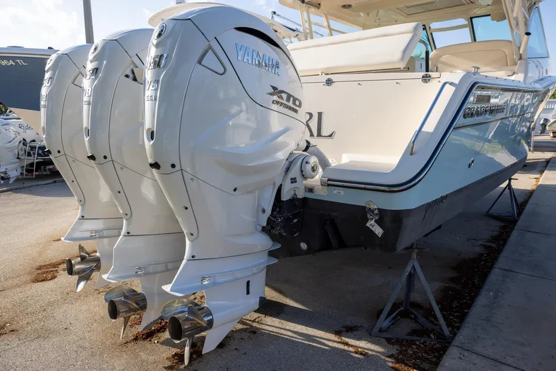 Slide: The Image of 2024 Grady-White Freedom 375 boat with triple Yamaha outboard engines. - 2