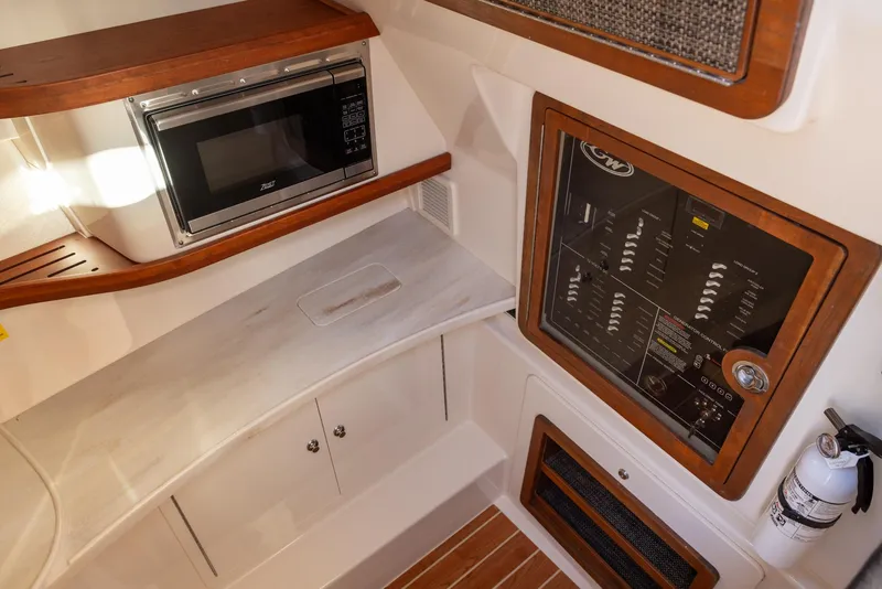 Slide: The Image of 2024 Grady-White Freedom 375 interior with microwave and control panel. - 23