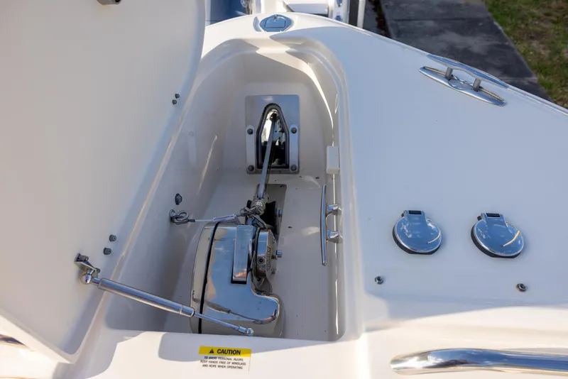 Slide: The Image of 2024 Grady-White Freedom 375 boat anchor compartment with chrome fittings and open hatch. - 25