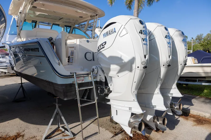 Slide: The Image of 2024 Grady-White Freedom 375 boat with triple Yamaha 450 engines, docked outdoors. - 4