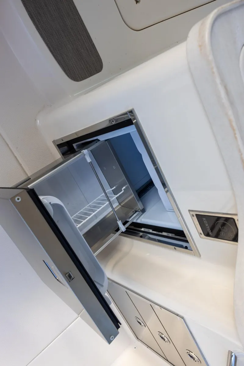 Slide: The Image of 2024 Grady-White Freedom 375 boat interior with open storage compartment. - 9