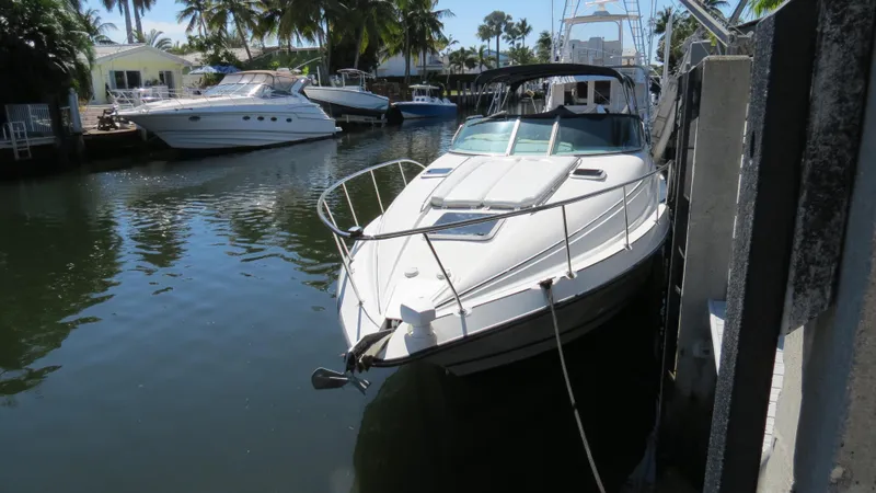 Slide: The Image of 1998 Doral 300 SC V Drive boat docked in a sunny marina. - 12