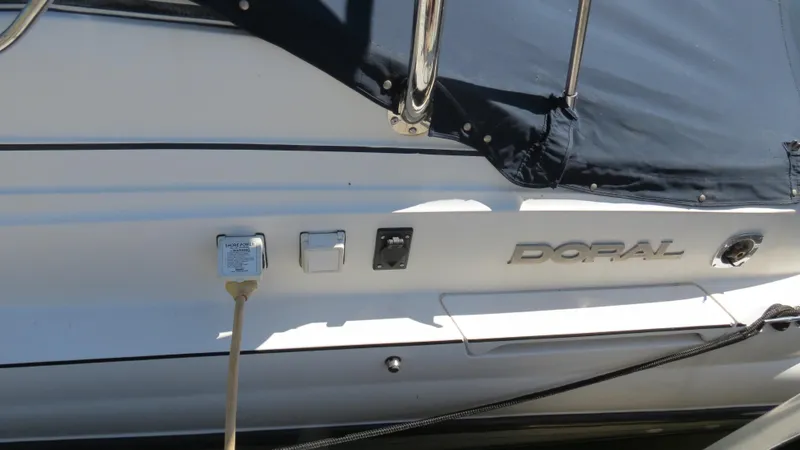 Slide: The Image of 1998 Doral 300 SC V Drive boat with power connection and cover. - 16