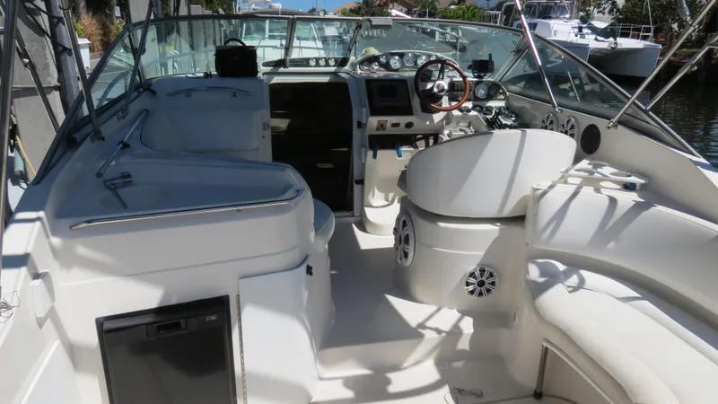 Slide: The Image of 1998 Doral 300 SC V Drive boat interior with steering wheel and seating area. - 18