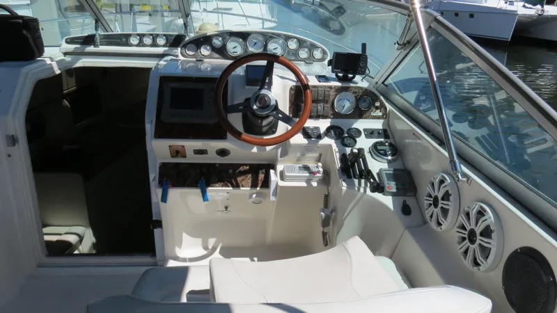 Slide: The Image of 1998 Doral 300 SC V Drive boat cockpit with steering wheel and control panel. - 21