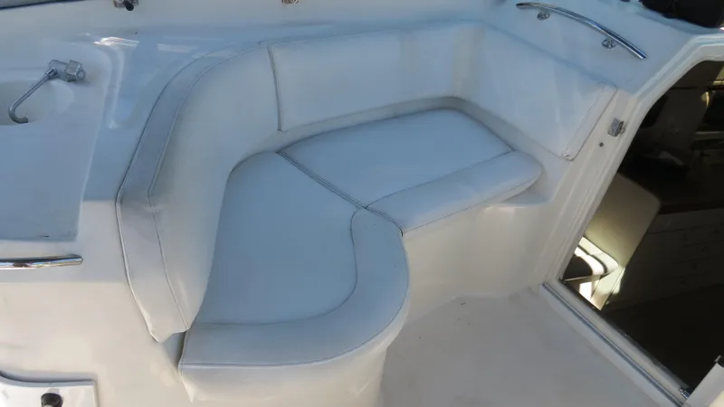 Slide: The Image of 1998 Doral 300 SC V Drive boat interior with white cushioned seating. - 22