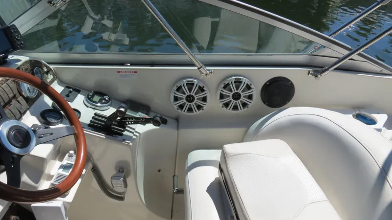 Slide: The Image of 1998 Doral 300 SC V Drive boat interior with steering wheel and control panel. - 24
