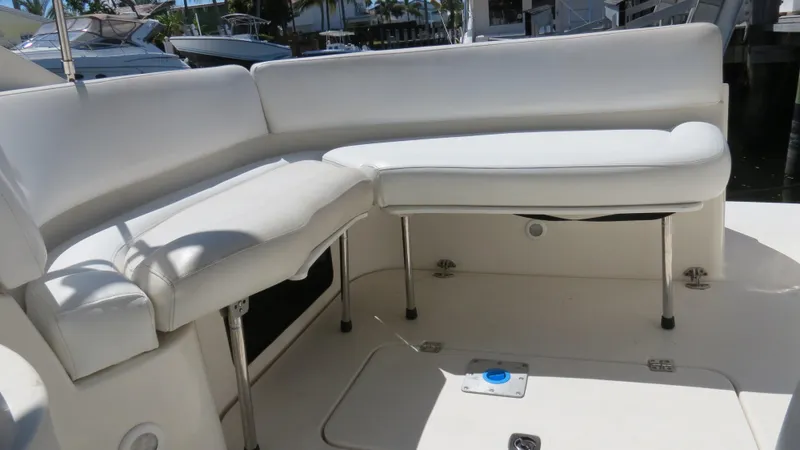 Slide: The Image of 1998 Doral 300 SC V Drive boat with white cushioned seating area. - 26