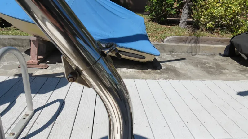 Slide: The Image of Chrome railing on a 1998 Doral 300 SC V Drive boat, dockside with blue cover. - 28