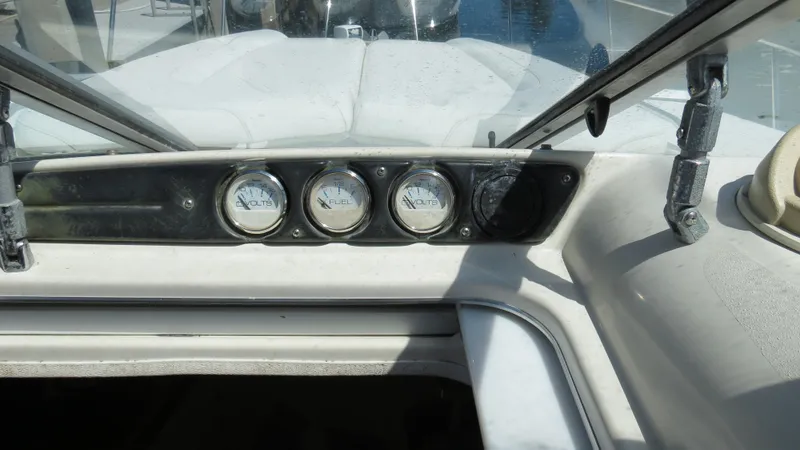 Slide: The Image of 1998 Doral 300 SC V Drive boat dashboard with gauges and windshield. - 33