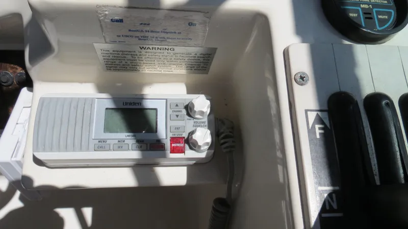 Slide: The Image of 1998 Doral 300 SC V Drive boat control panel with radio and throttle. - 35