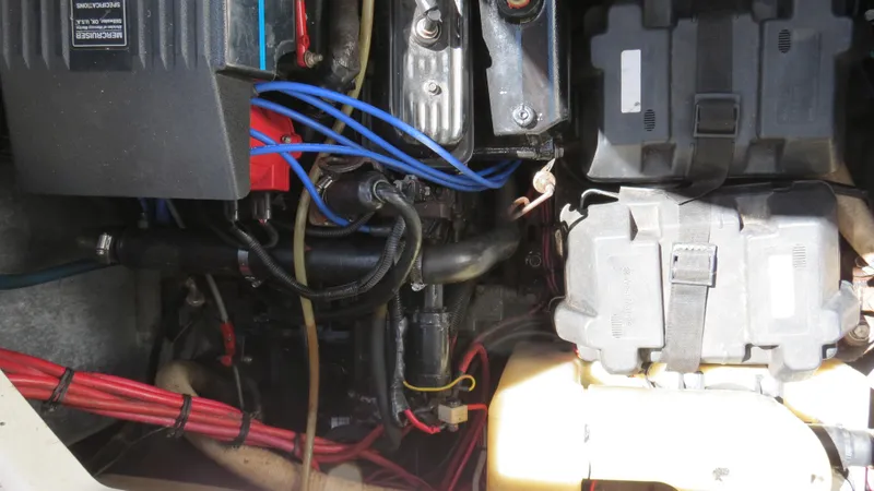 Slide: The Image of Engine compartment of a 1998 Doral 300 SC V Drive boat, showing wiring and components. - 42