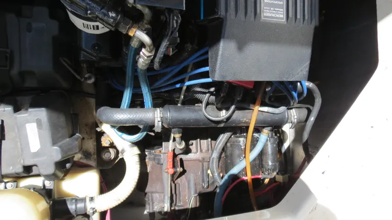 Slide: The Image of Engine compartment of a 1998 Doral 300 SC V Drive boat, showing hoses and components. - 43