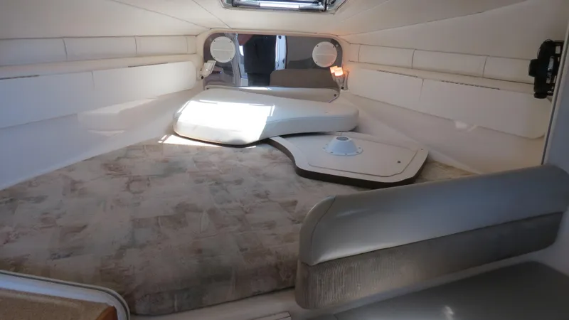 Slide: The Image of 1998 Doral 300 SC V Drive cabin interior with seating and storage. - 45