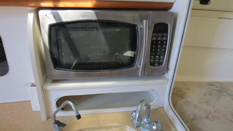Slide: The Image of Microwave in 1998 Doral 300 SC V Drive boat interior kitchen area. - 49