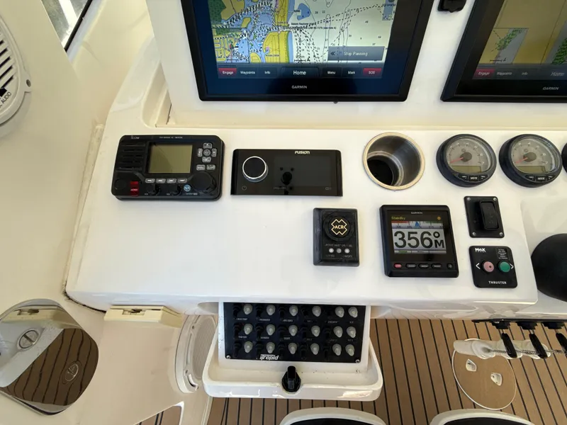 Slide: The Image of Control panel of a 2013 Intrepid 390 Sport Yacht with navigation and communication equipment. - 11