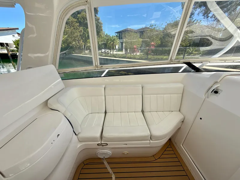 Slide: The Image of 2013 Intrepid 390 Sport Yacht interior with white seating and teak flooring. - 16