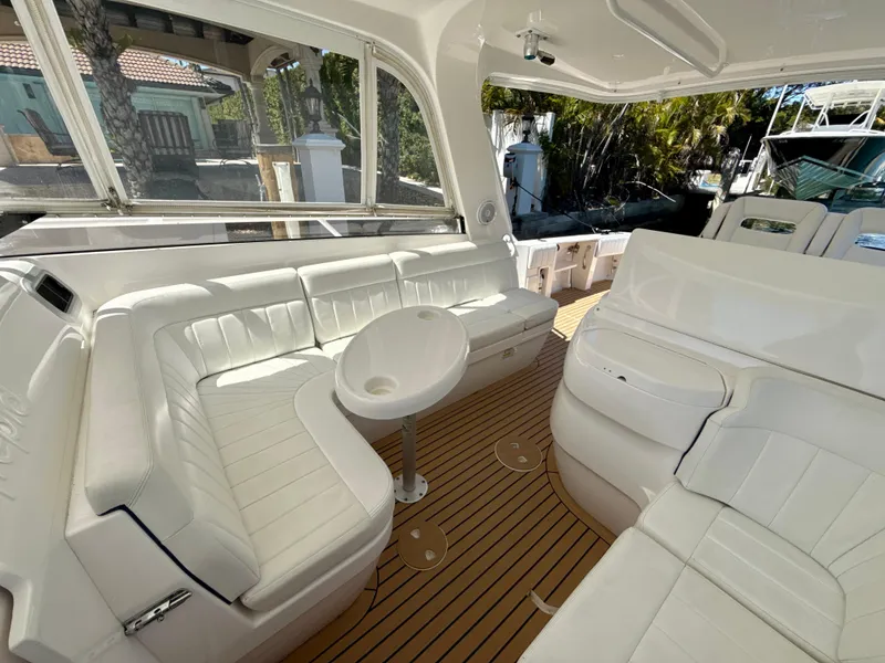 Slide: The Image of Luxurious 2013 Intrepid 390 Sport Yacht interior with white seating and wooden flooring. - 17