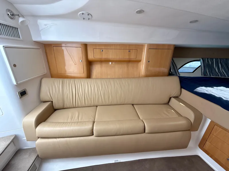 Slide: The Image of Interior of 2013 Intrepid 390 Sport Yacht with beige leather sofa and wooden cabinets. - 19