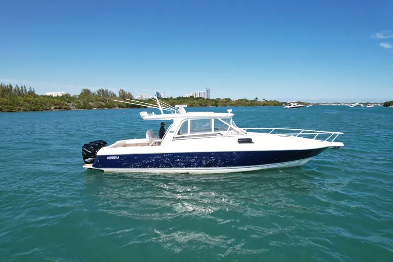 Slide: The Image of 2013 Intrepid 390 Sport Yacht cruising on clear blue waters. - 2
