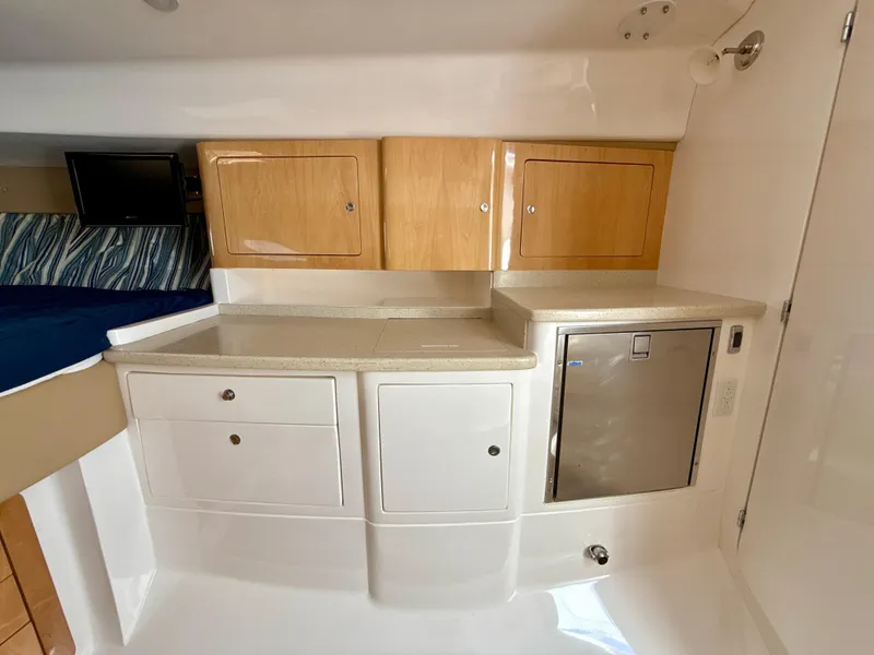Slide: The Image of 2013 Intrepid 390 Sport Yacht interior with cabinets and mini fridge. - 20