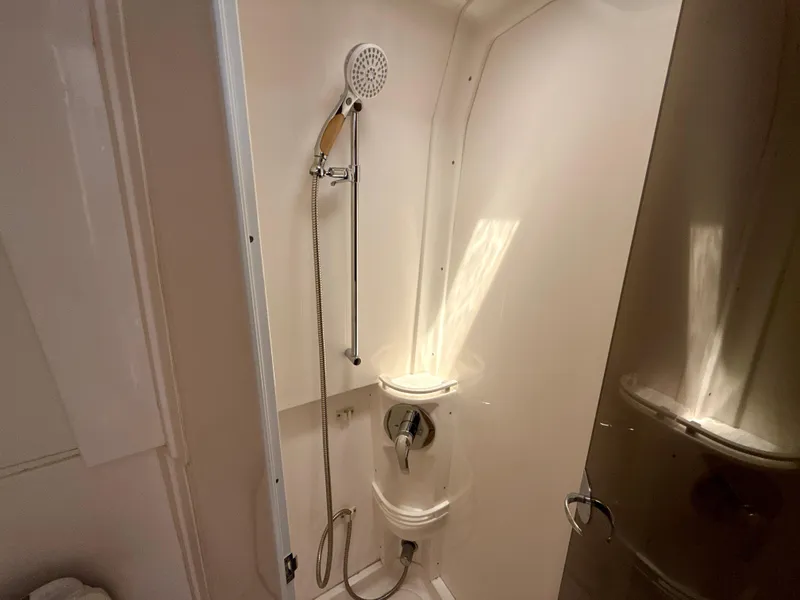 Slide: The Image of Shower area in a 2013 Intrepid 390 Sport Yacht, featuring a handheld showerhead. - 23