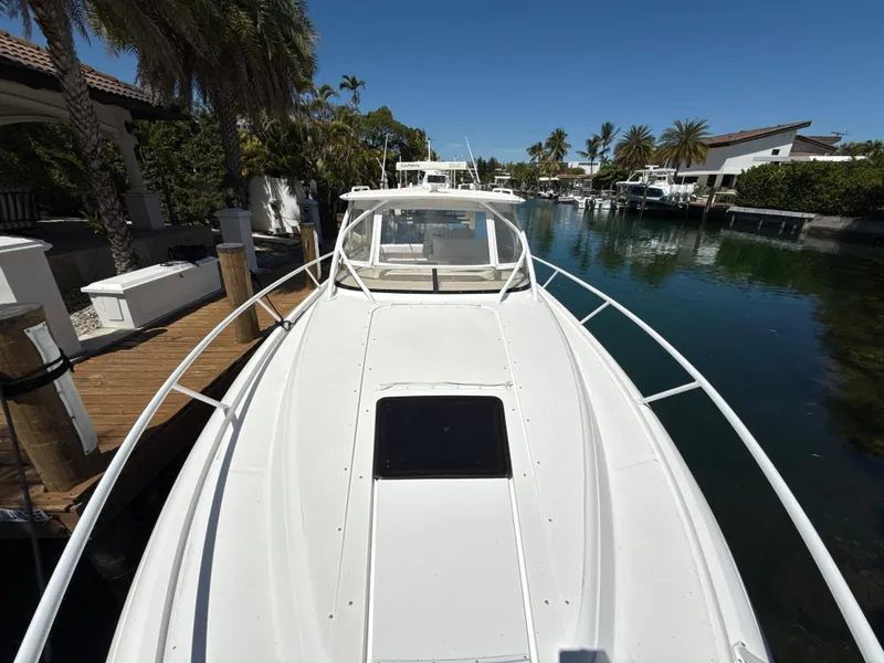 Slide: The Image of 2013 Intrepid 390 Sport Yacht docked in a scenic waterfront setting. - 25