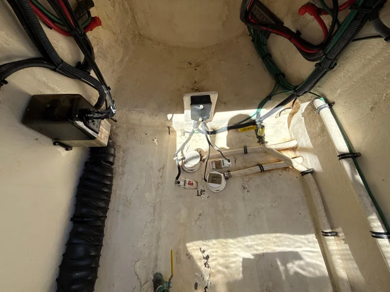 Slide: The Image of Bilge area of a 2013 Intrepid 390 Sport Yacht, showing wiring and plumbing components. - 26