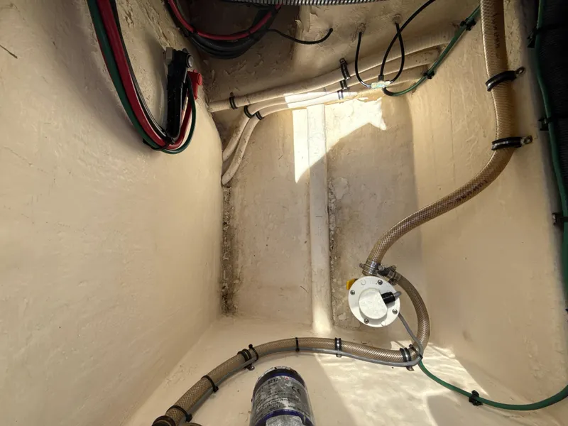 Slide: The Image of Bilge area of a 2013 Intrepid 390 Sport Yacht with visible wiring and hoses. - 27