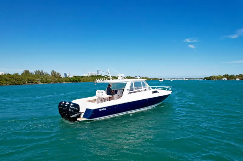 Slide: The Image of 2013 Intrepid 390 Sport Yacht cruising on clear blue waters under a sunny sky. - 3