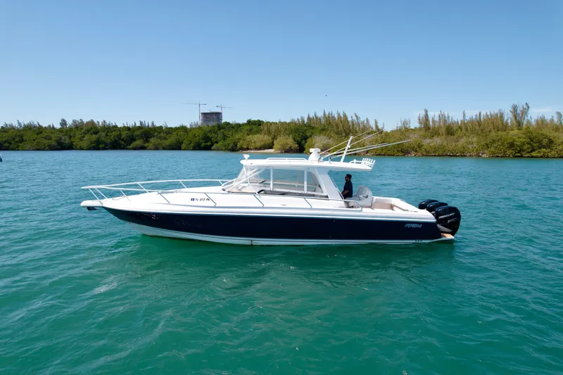 Slide: The Image of 2013 Intrepid 390 Sport Yacht on calm water, side view. - 4