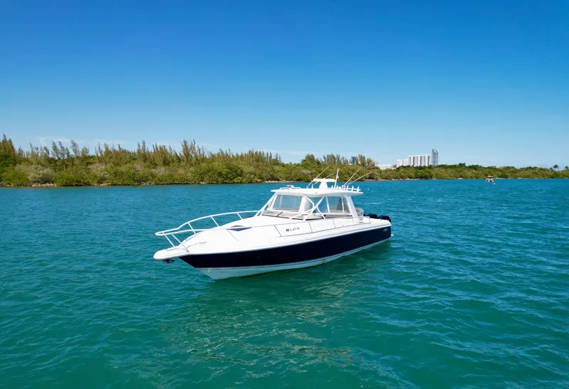 Slide: The Image of 2013 Intrepid 390 Sport Yacht on blue water, clear sky background. - 5