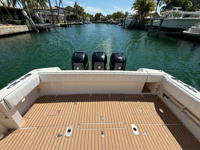 Slide: The Image of 2013 Intrepid 390 Sport Yacht with triple engines, docked in a scenic canal. - 6