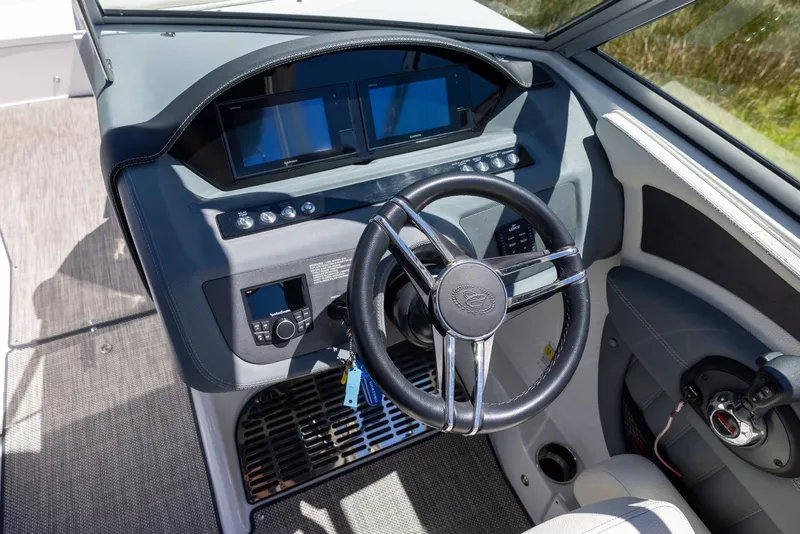 Slide: The Image of 2019 Cobalt 25SC boat dashboard with steering wheel and digital displays. - 10