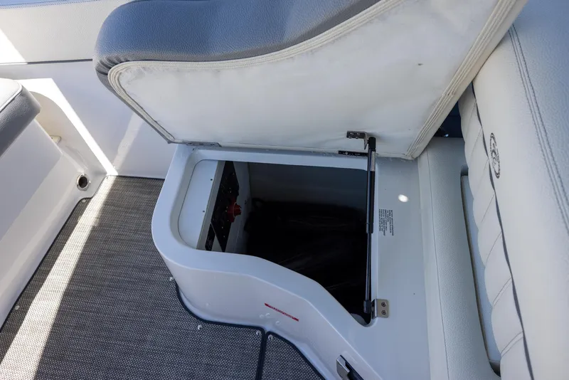 Slide: The Image of Open storage compartment in 2019 Cobalt 25SC boat with cushioned seating. - 9